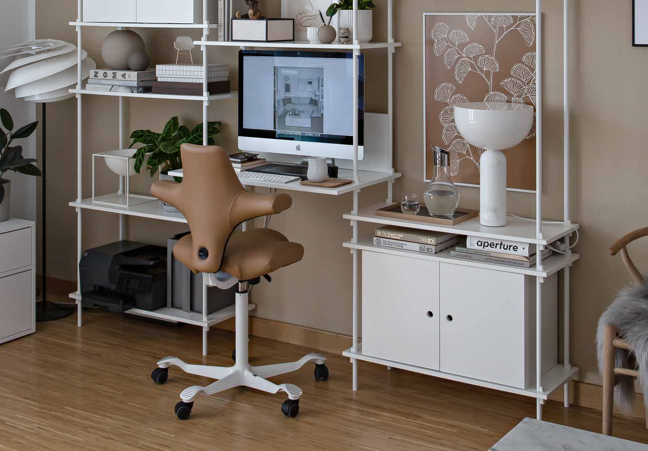 back view of hag capisco chair in brown paloma leather in home workspace