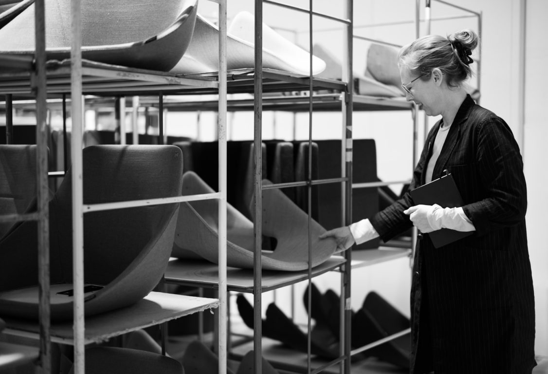 Offecct designers in factory examining components