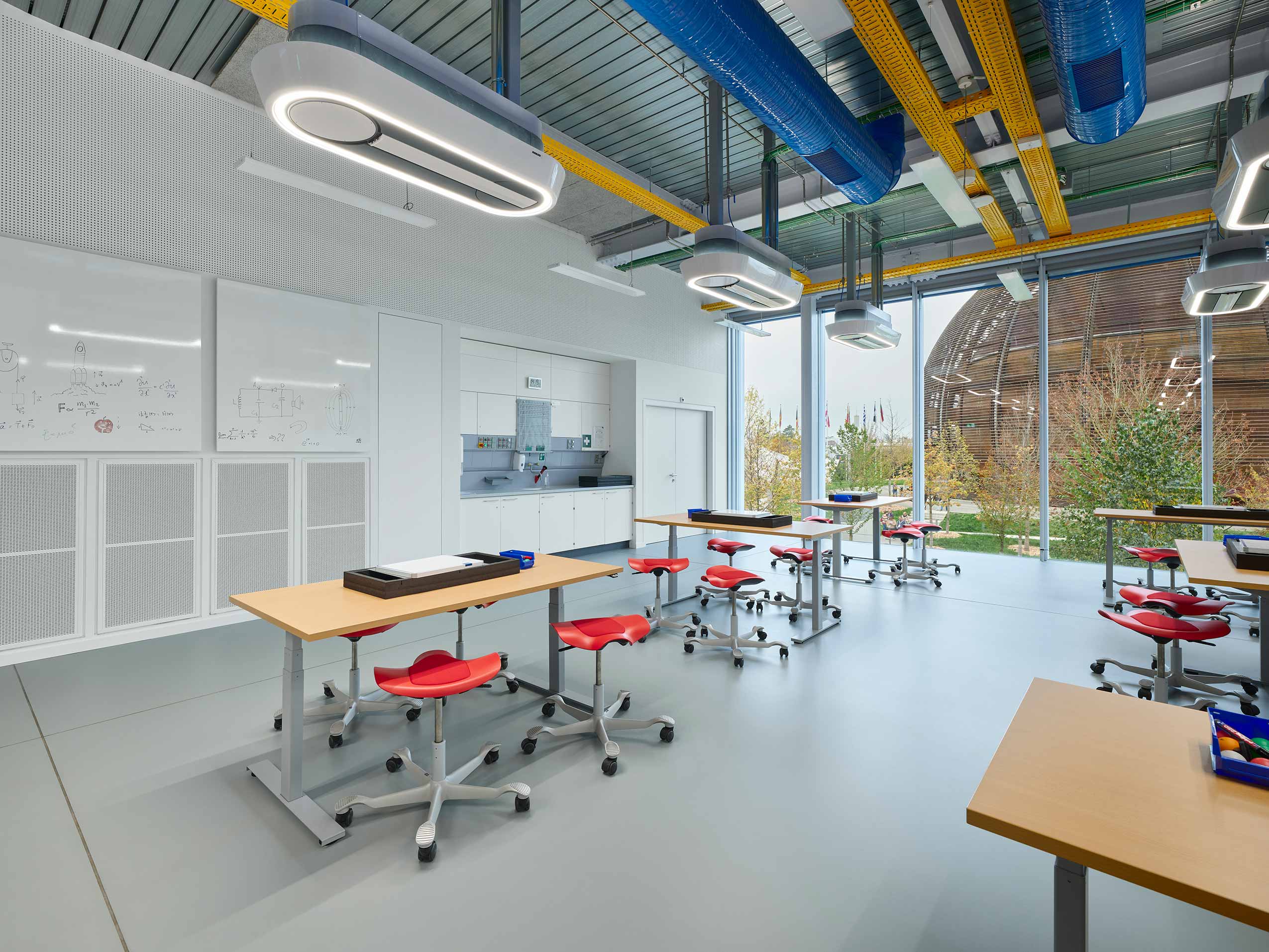 Red HÅG Capisco Puls Stools in children's workshop lab at European Laboratory for Particle Physics (CERN) | Photo : Sarah Reuland
