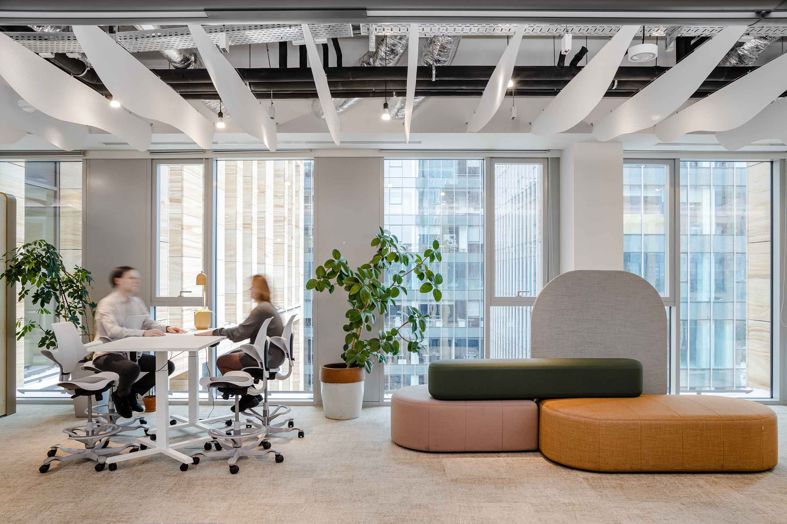 Interior of arups new office with 2 people sat at a table in HÅG Capisco puls 