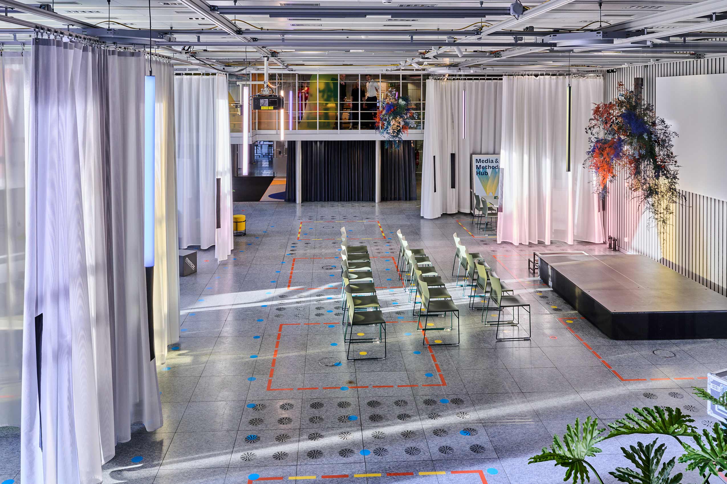 large open space in ETH Zurich, with rows of PRofim Ariz chairs lined up for an event infront of a stage
