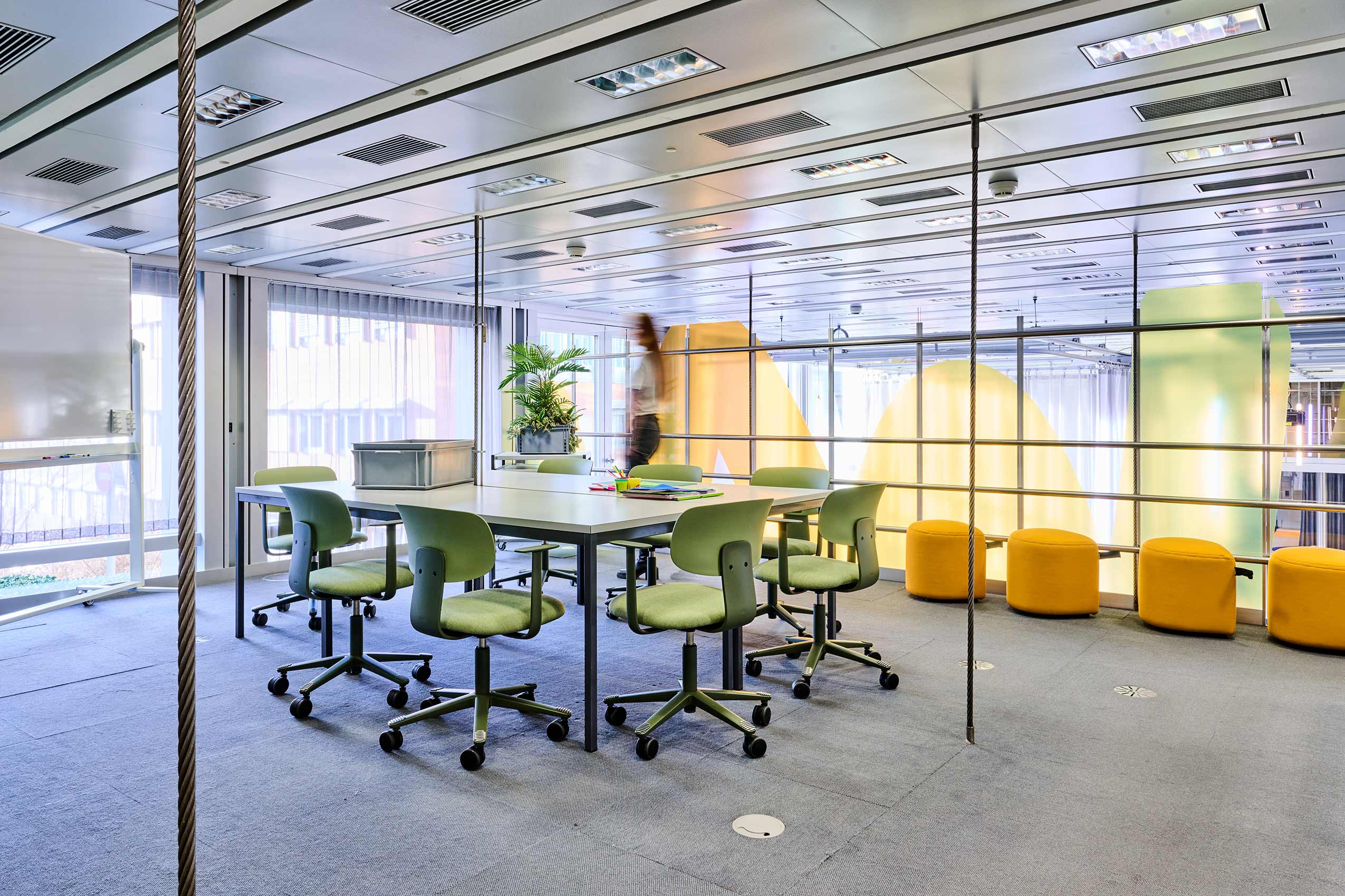 another angle of interior of meeting room at ETH zurich, with green HÅG Celi chairs around a table