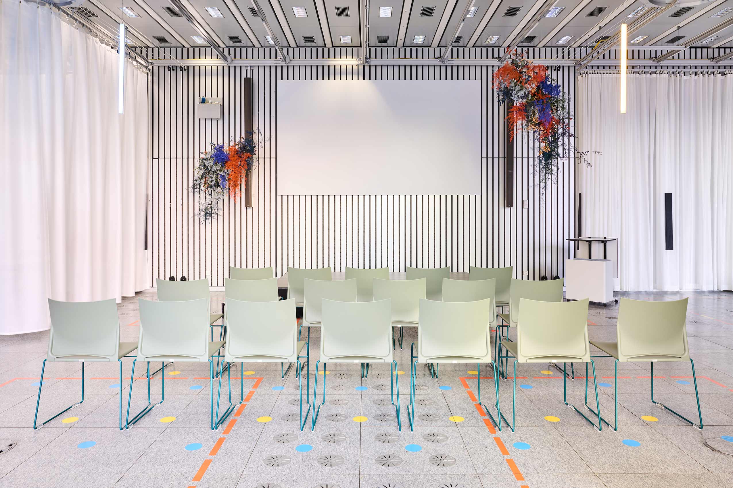 Another angle of large open space in ETH Zurich, with rows of PRofim Ariz chairs lined up for an event infront of a stage