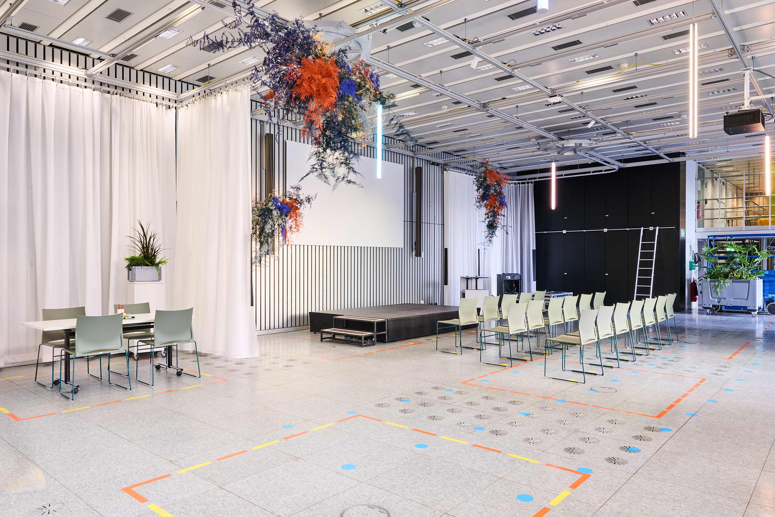yet another angle of large open space in ETH Zurich, with rows of PRofim Ariz chairs lined up for an event infront of a stage
