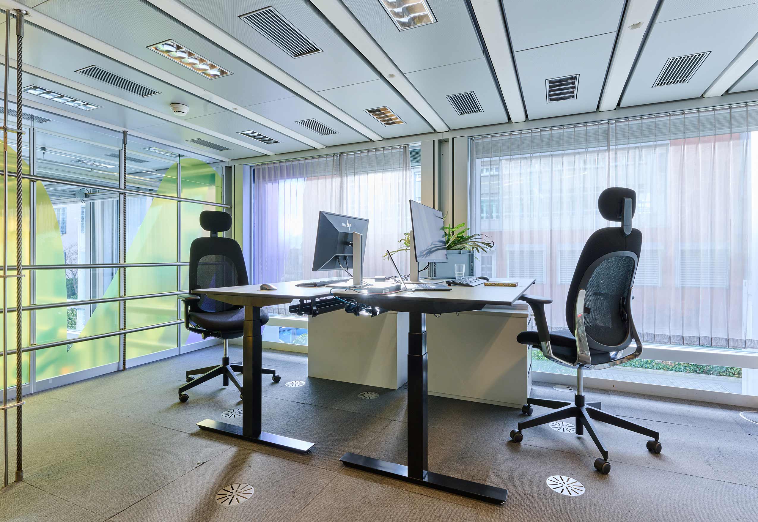 2 giroflex 40 chairs at back to back workstations in an office