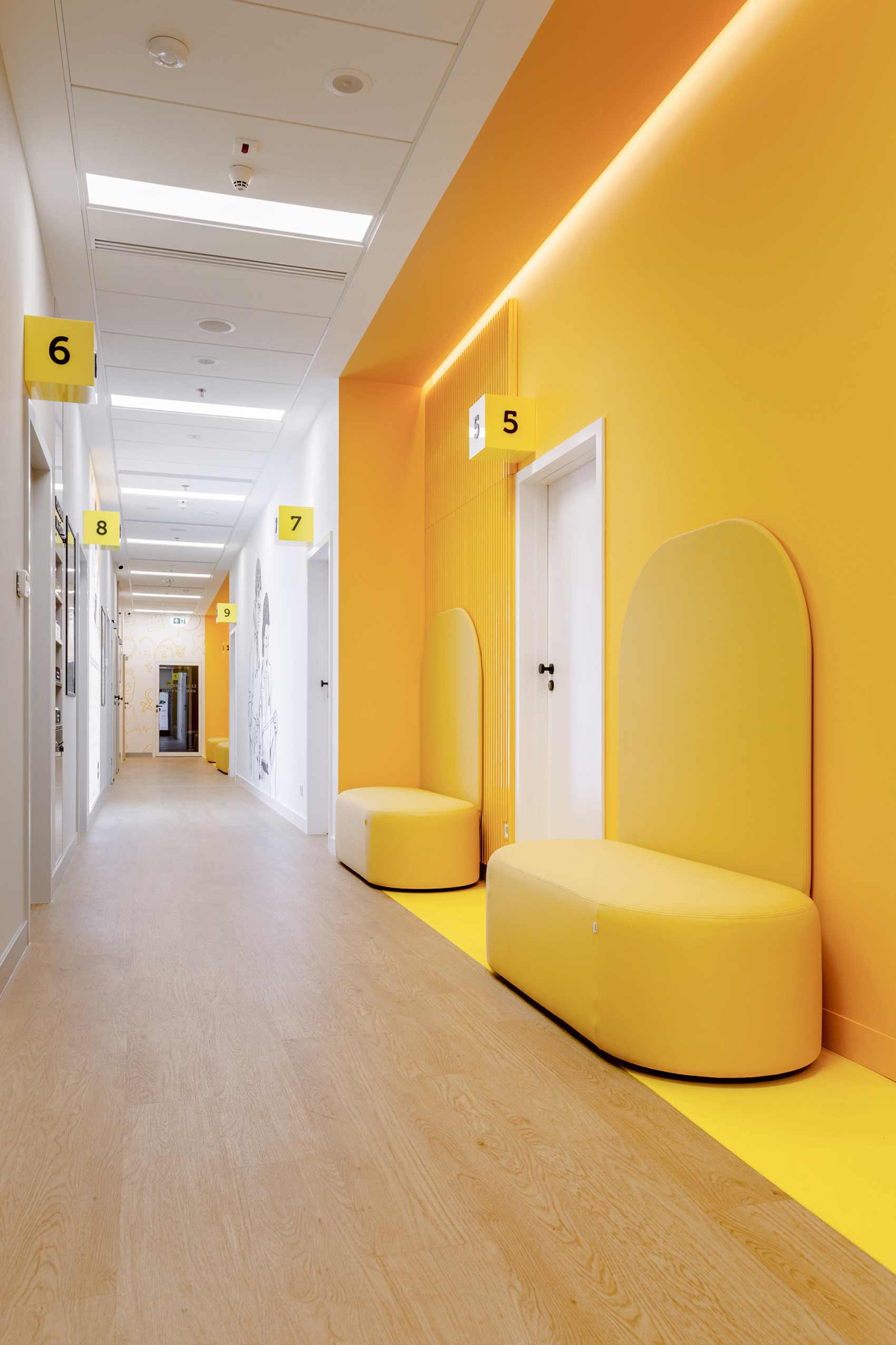 hostpial hallway with yellow walls and wooden floors, and Profim Revo Sofas along the wall
