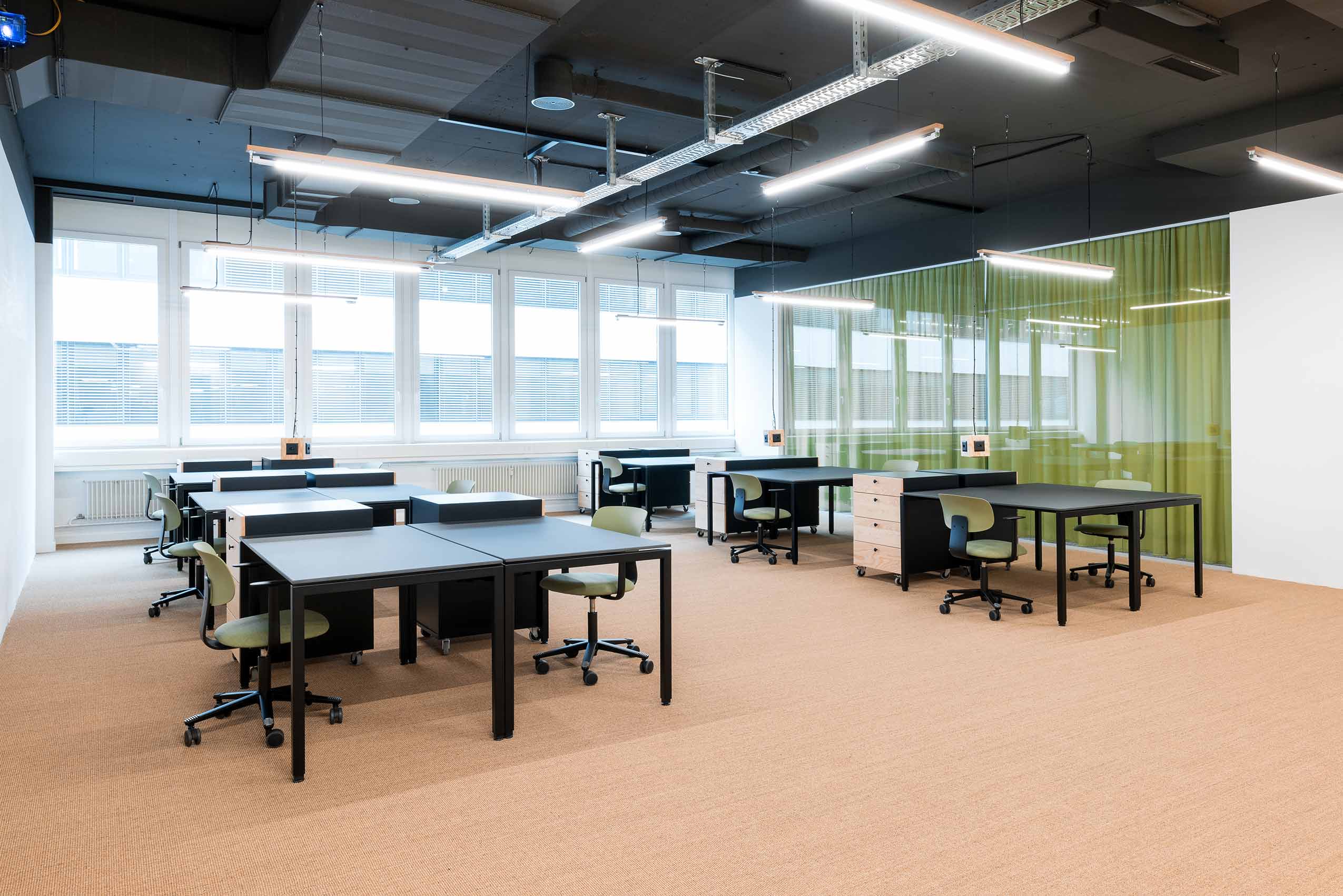 university desks with bright lights on the ceiling and chairs and tables on the floor