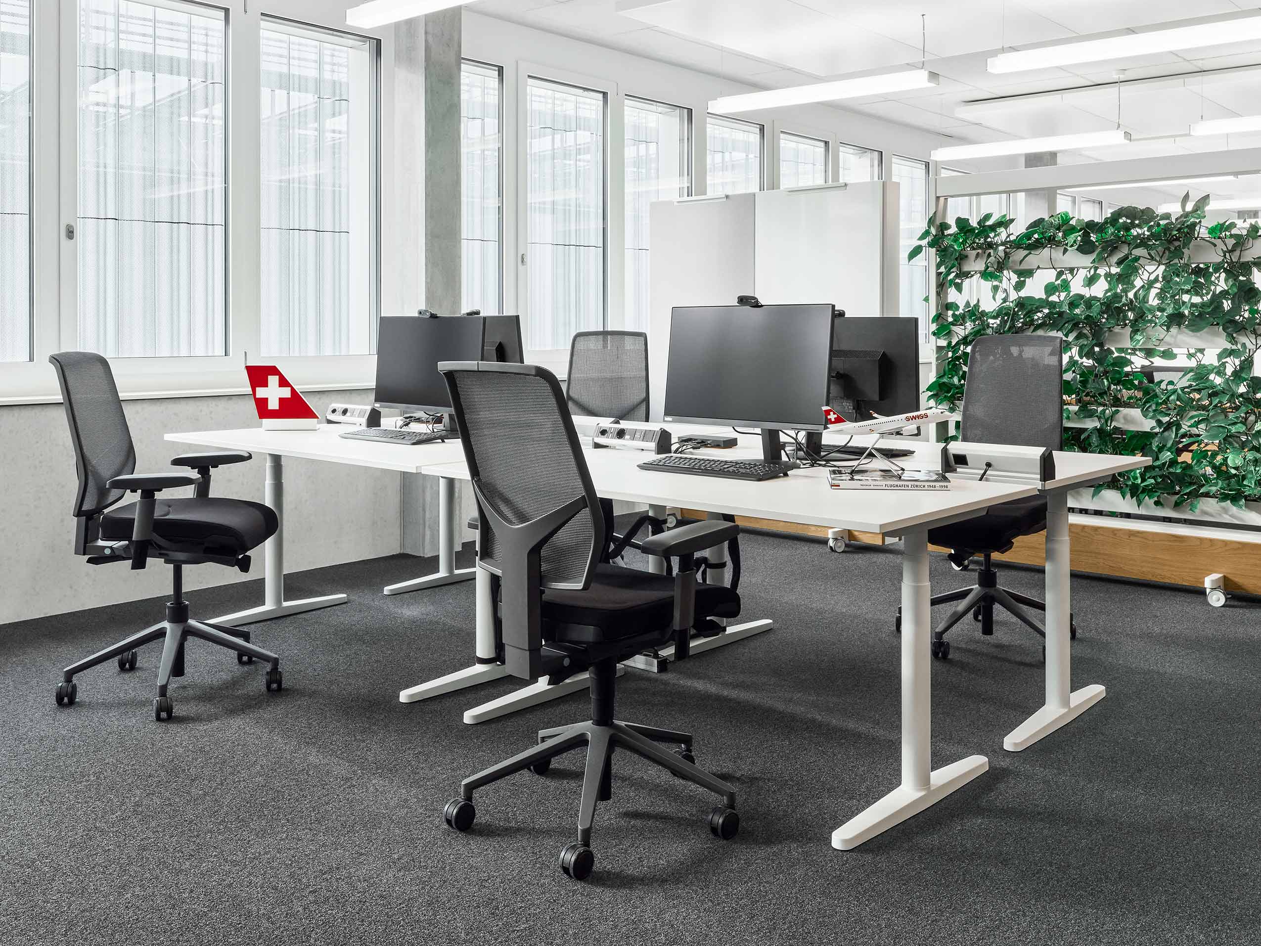 Angle 3 of Lufthana's new office, featuring Giroflex 68 chairs in black at workstations