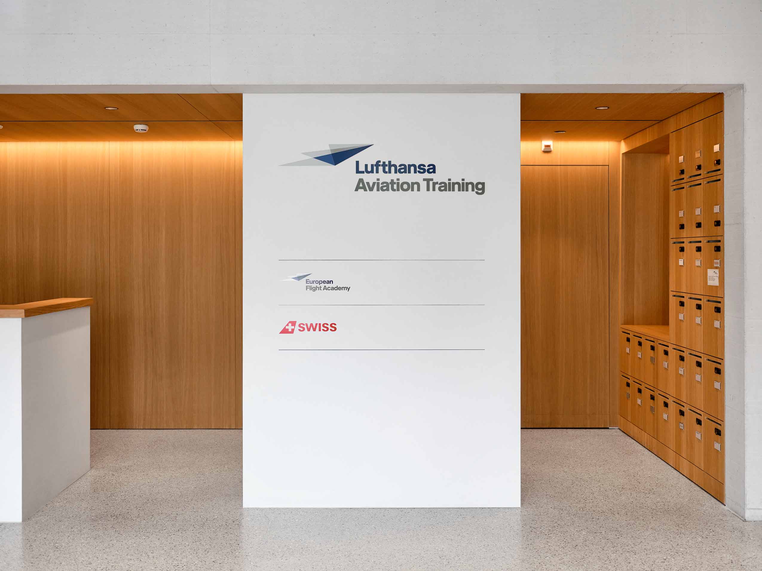 a board shwoing lufthansas name, on a wall inside Lufthansa's new office