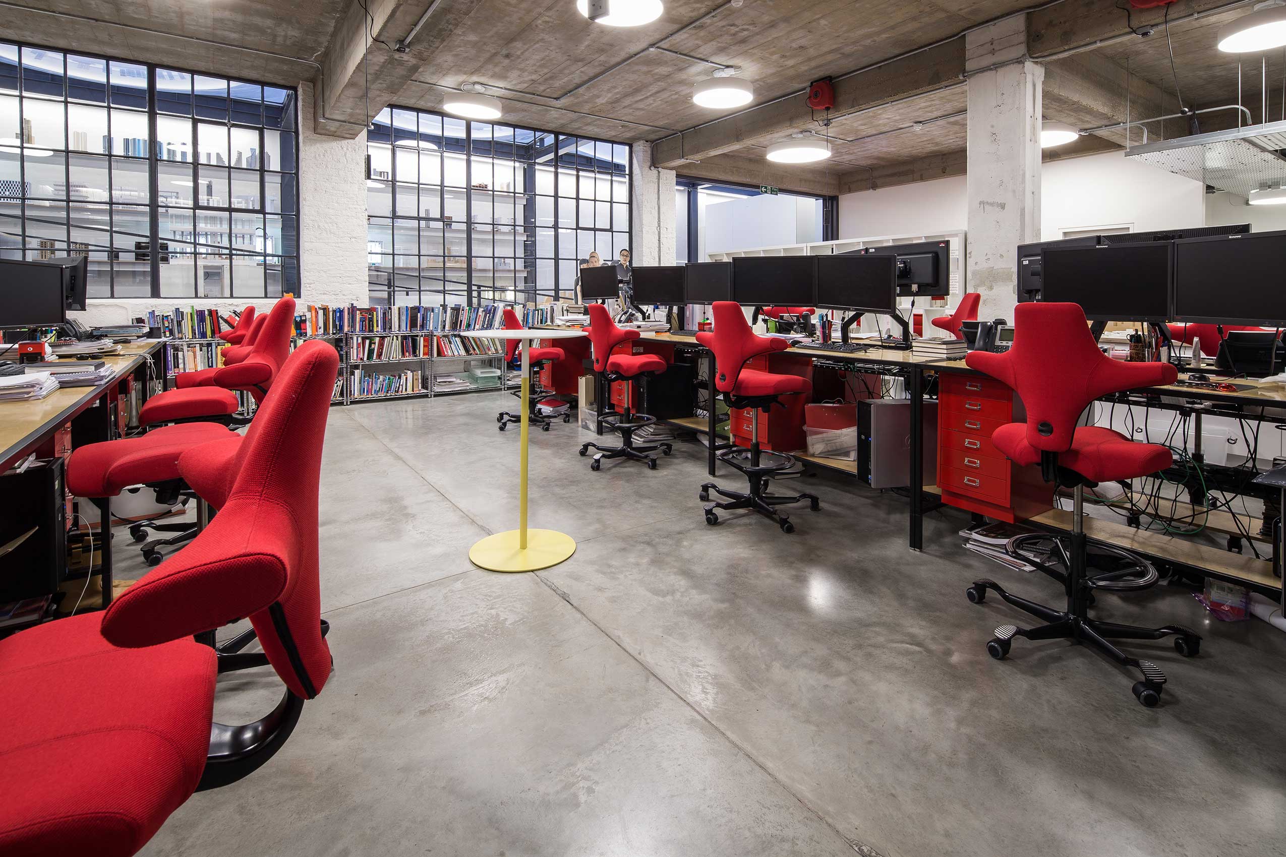 angle 4 of interior of make architects office, with bright red HÅG Capisco chairs