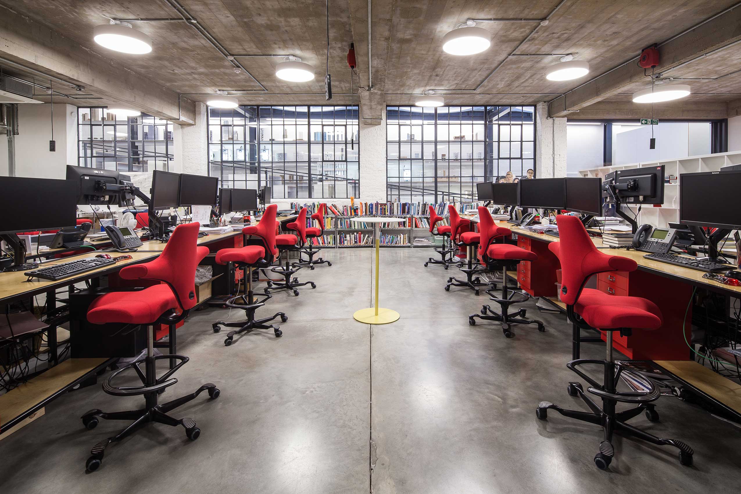 Angle 5 of interior of make architects office, with bright red HÅG Capisco chairs