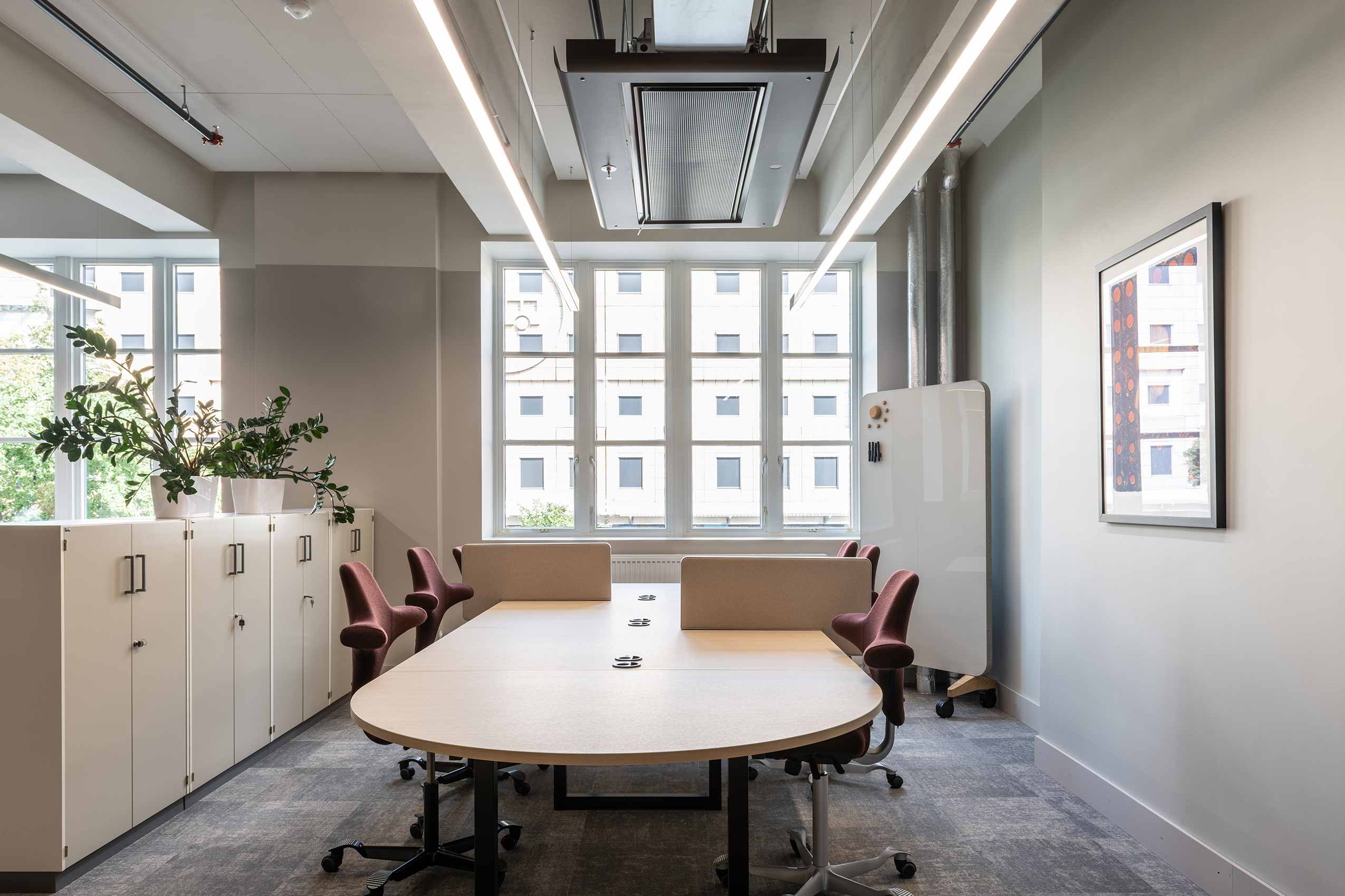 4 red HÅG Capisco chairs around a meeting table in Nortura office