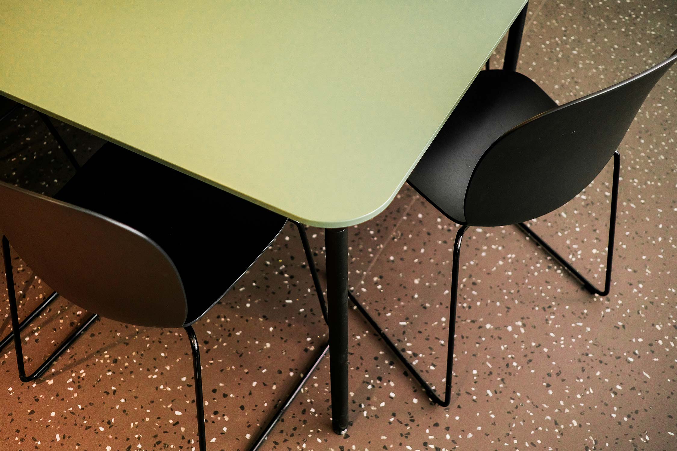 close up shot looking down on Profim Noor chairs in black around a table