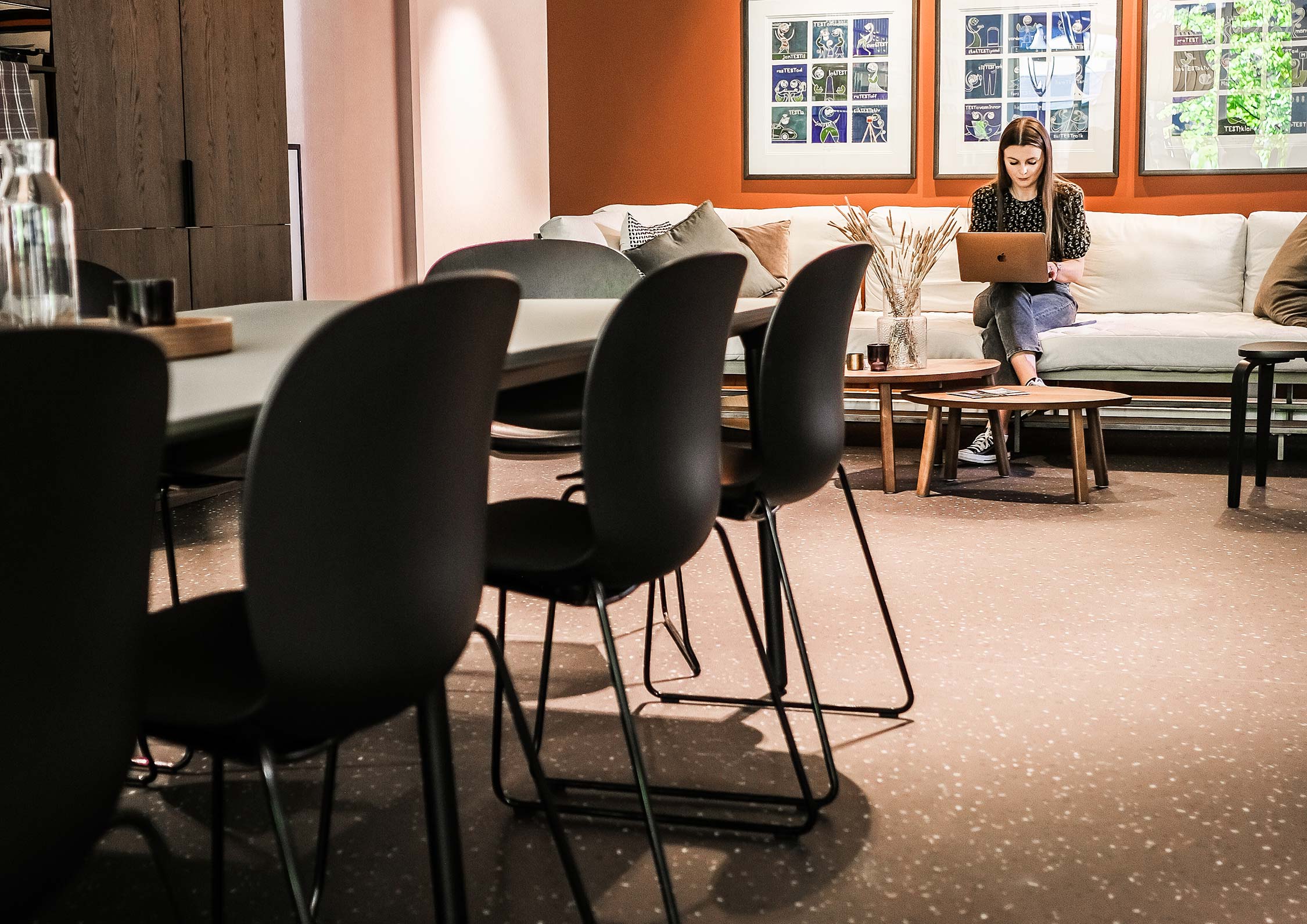 Angle 3 of 2 people sat at a table on RBM Noor chairs, in an office collaboration area 