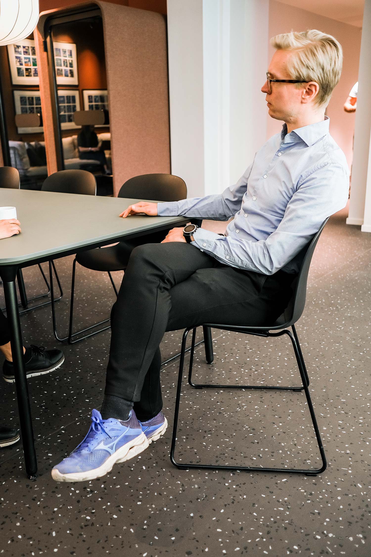 Angle 4 of 2 people sat at a table on RBM Noor chairs, in an office collaboration area 