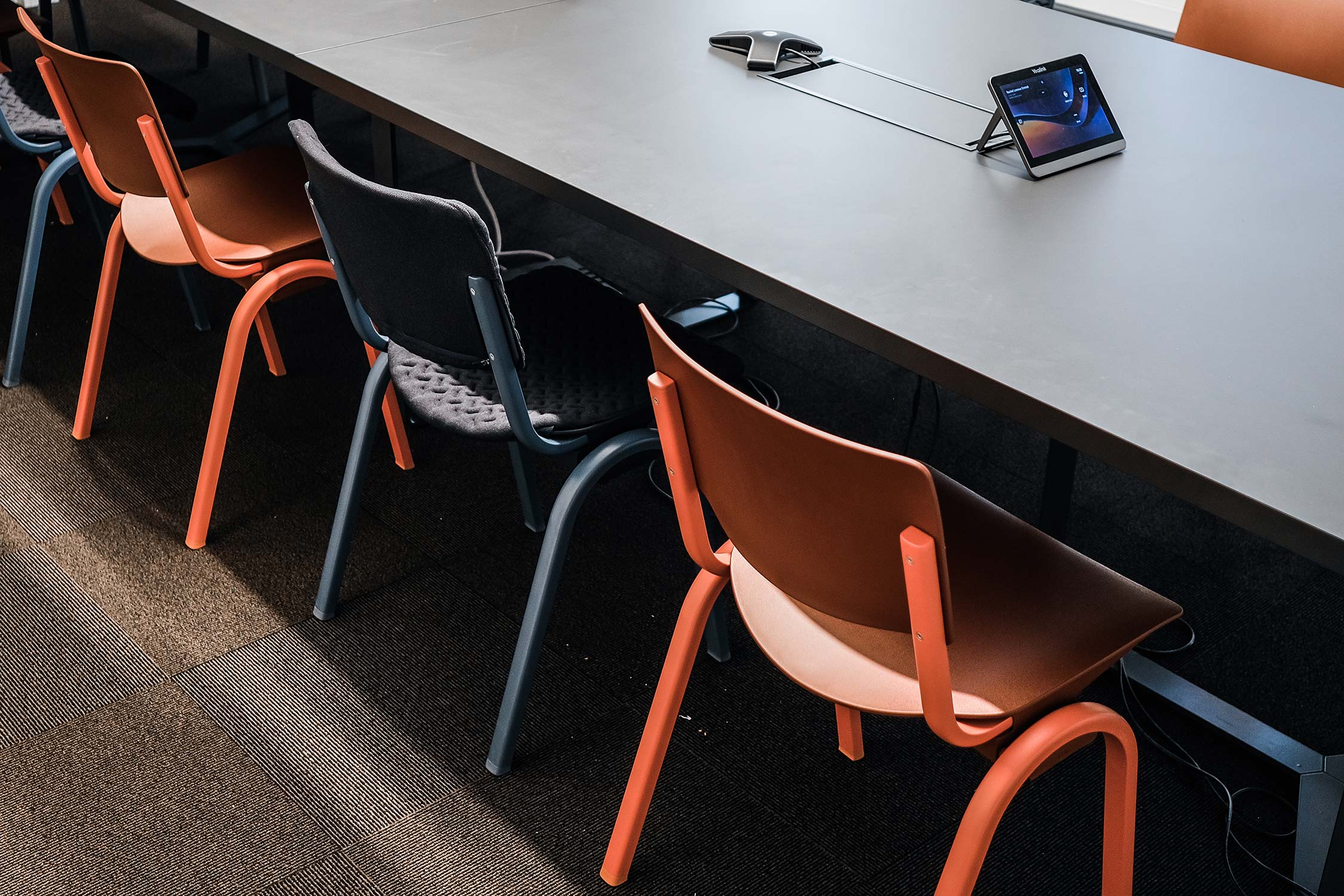 Blue and reb HÅG Celi chairs around a meeting table