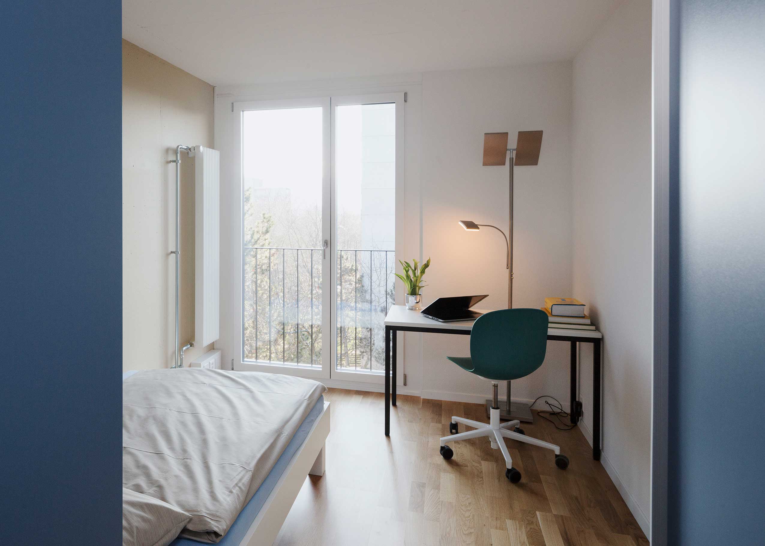 Profim Noor in bedroom study space at Student Lodge accommodation | Photo : Daniel Sutter