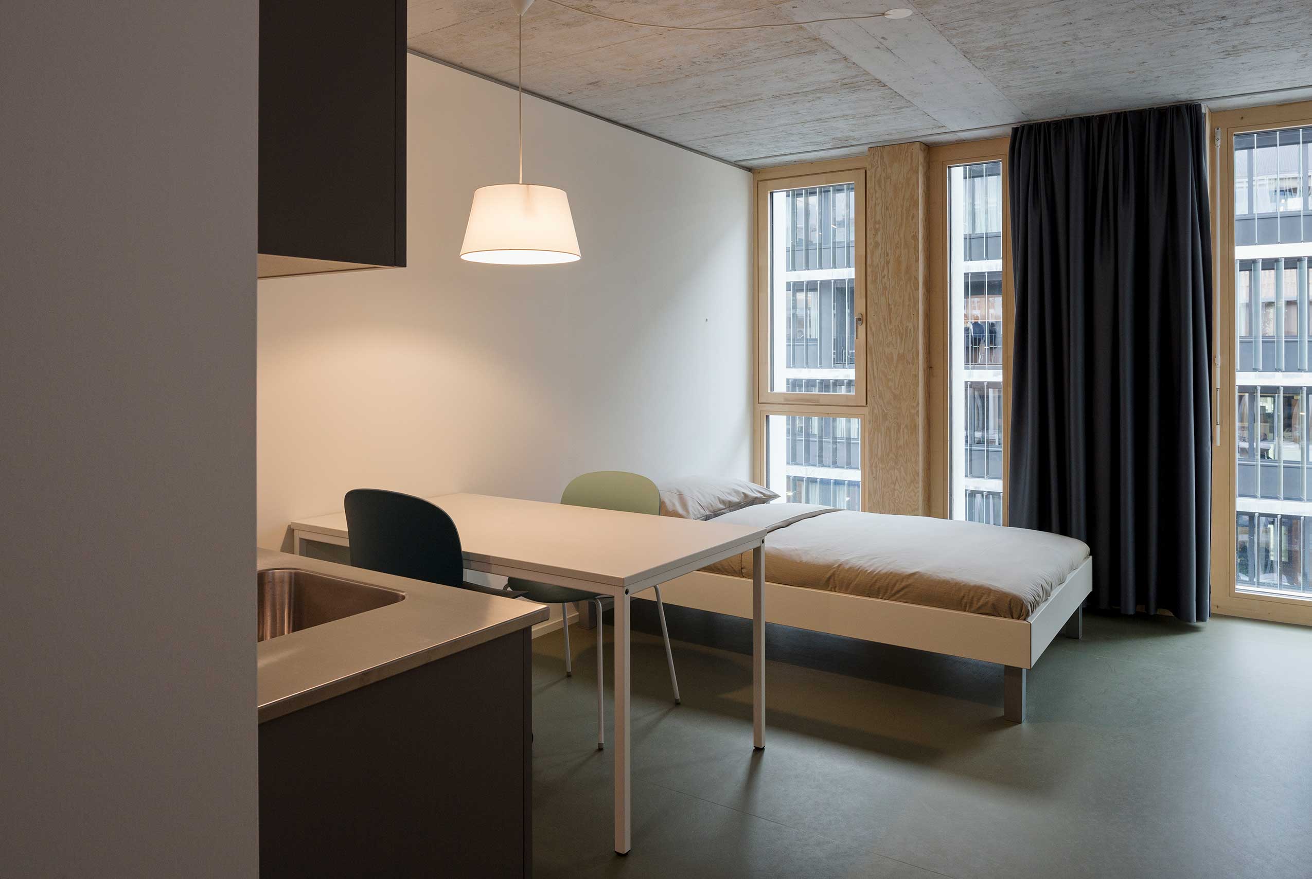 Profim Noor in bedroom study space at Student Lodge accommodation | Photo : Daniel Sutter