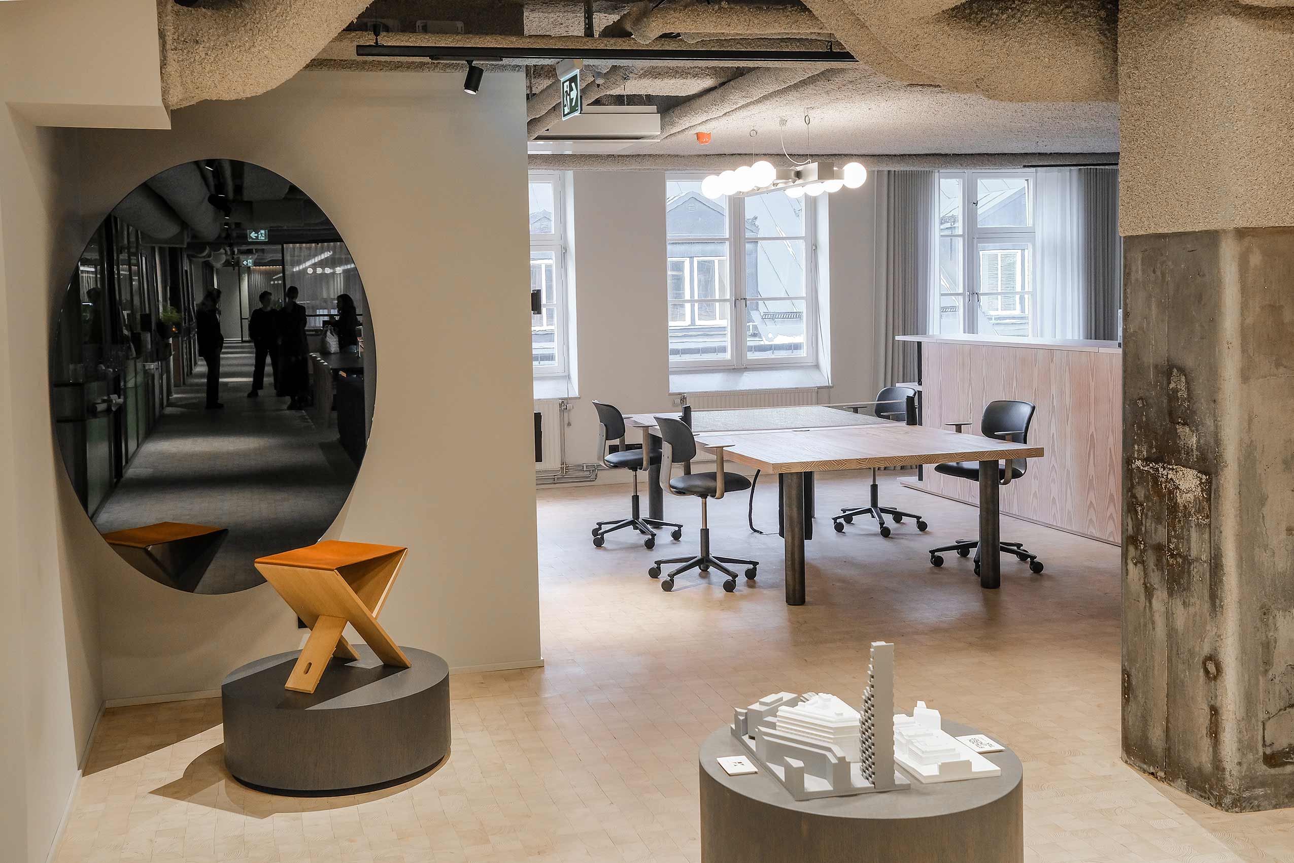 wide view of office meeting room with hallway filled with art in the foreground