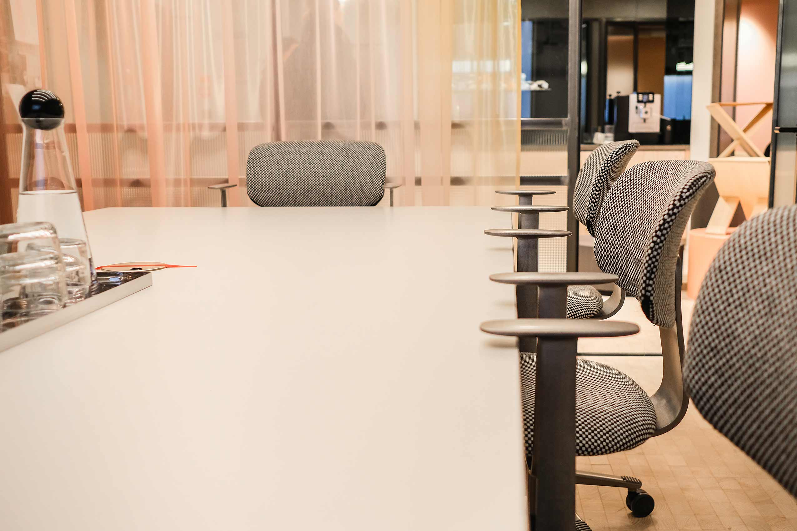HÅG Tion chairs around a meeting room table, the camera is at the level of the table.