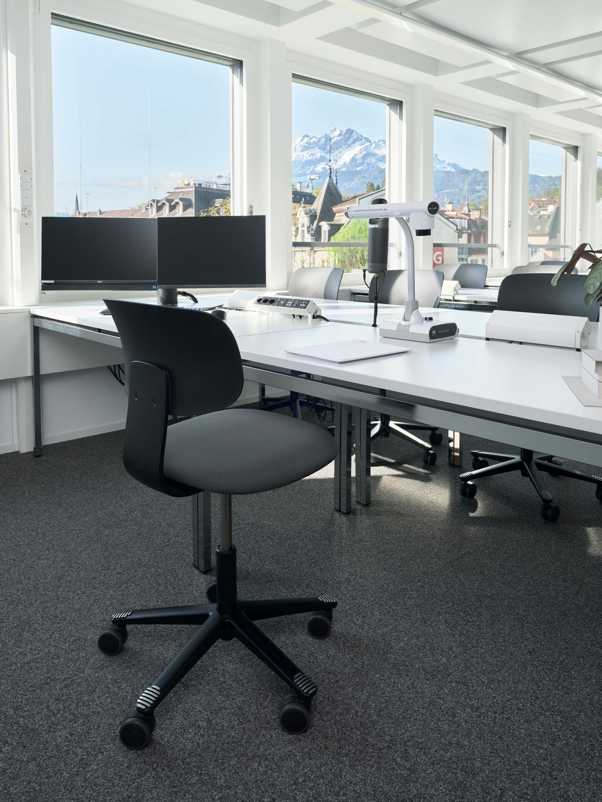 HÅG Tion chair in black behind a white desk in a classroom