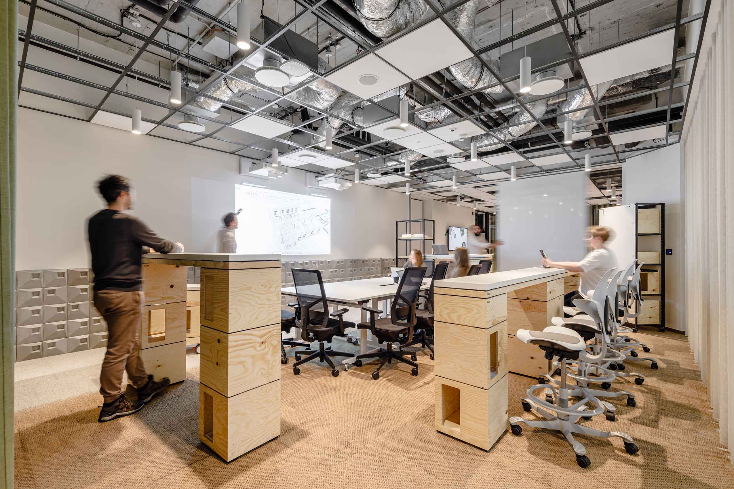 small office space with white HÅG Capisco Puls chairs and wooden flloring