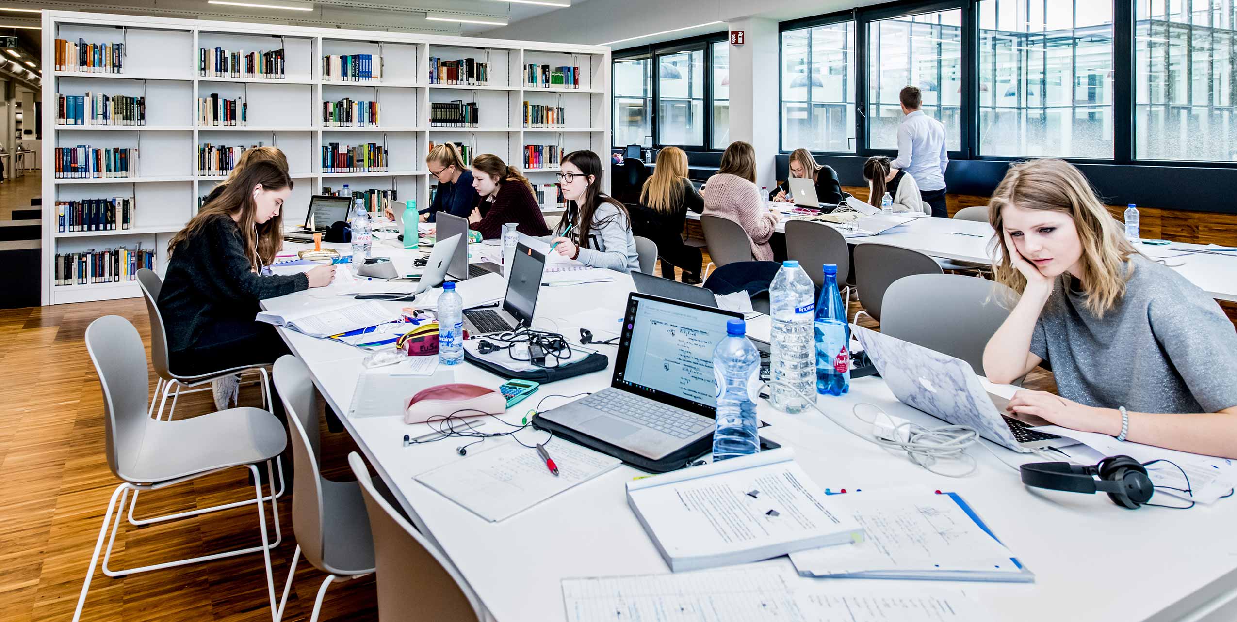 students studying in university library