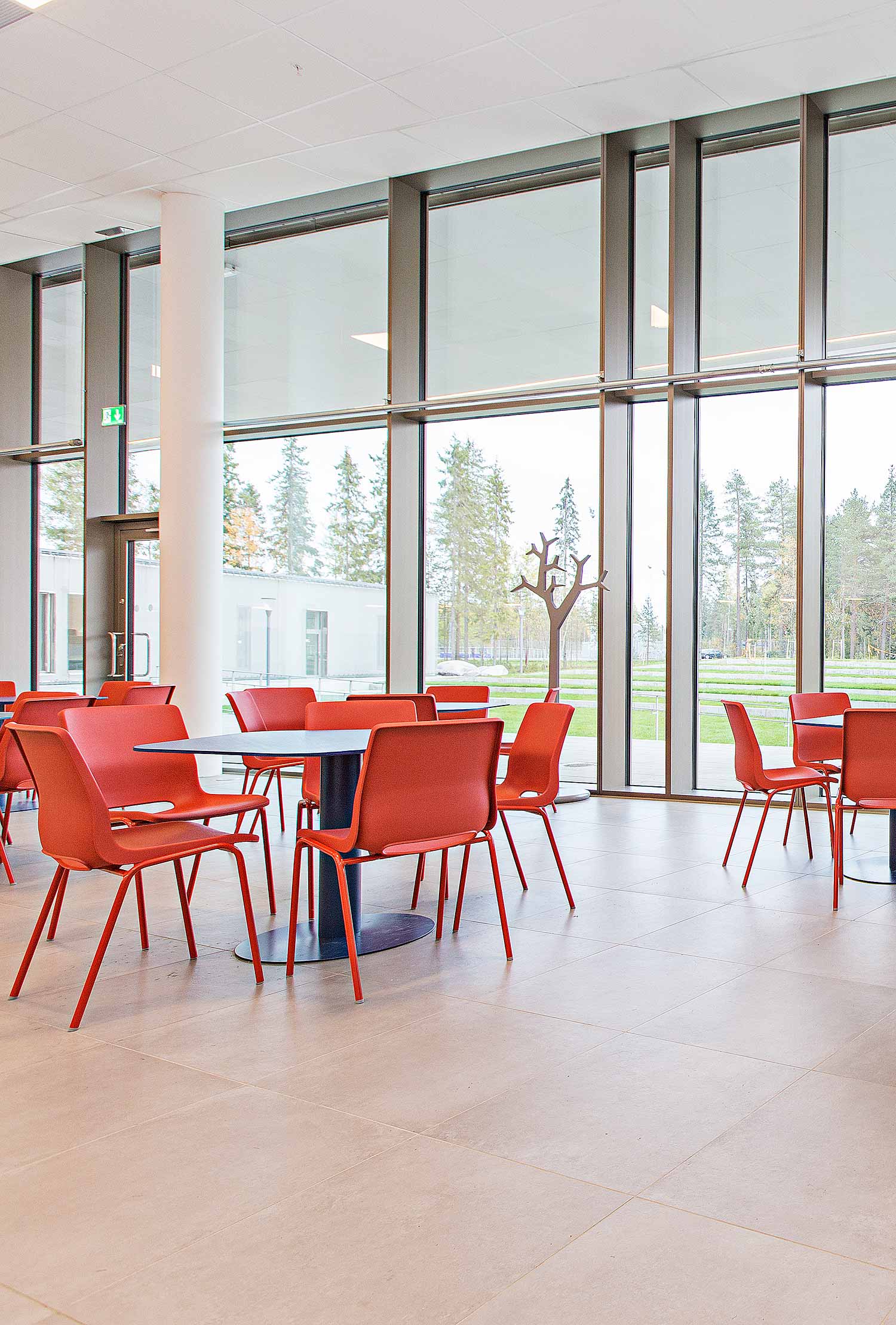 Bright Red RBM Ana plastic school chairs in waiting area at Minerva Highschool